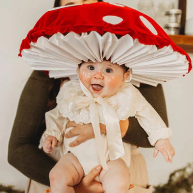 Baby in a mushroom hat costume